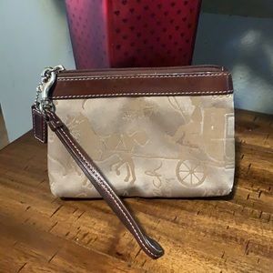 Brown and tan coach wristlet.